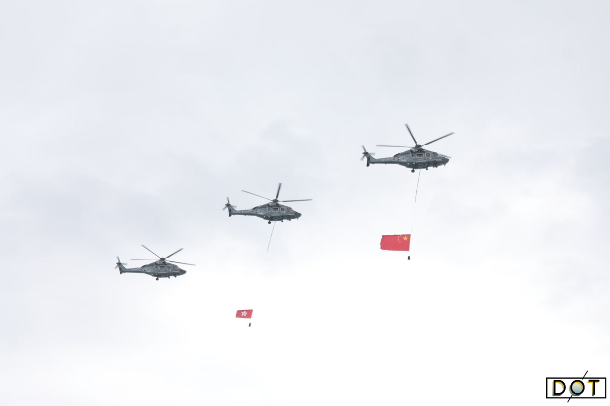 Helicopters carrying the red national and HKSAR flags flew over Victoria Harbor in celebration and a fireboat sprayed a water-column salute. (DotDotNews)