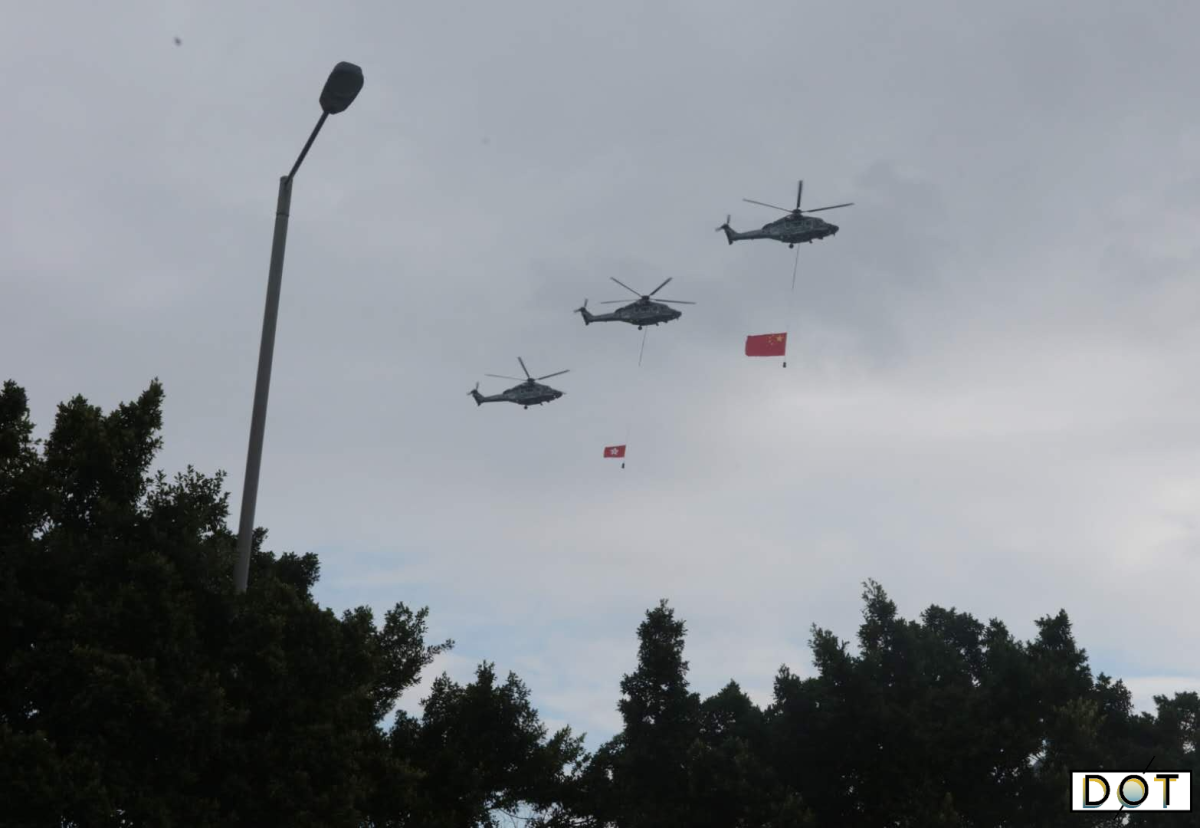 Helicopters carrying the red national and HKSAR flags flew over Victoria Harbor in celebration and a fireboat sprayed a water-column salute. (DotDotNews)