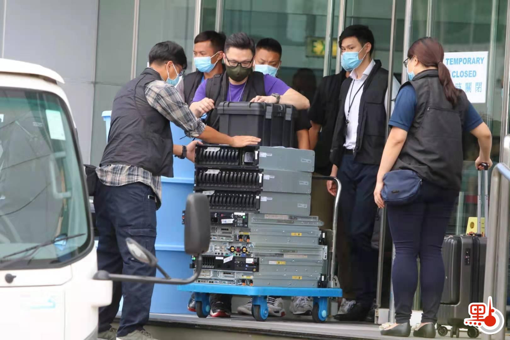 國安處調查發現，自2019年開始，在《蘋果日報》中有數十篇文章呼籲制裁香港與中華人民共和國。圖為警員檢走大樓內證物。（點新聞記者攝）