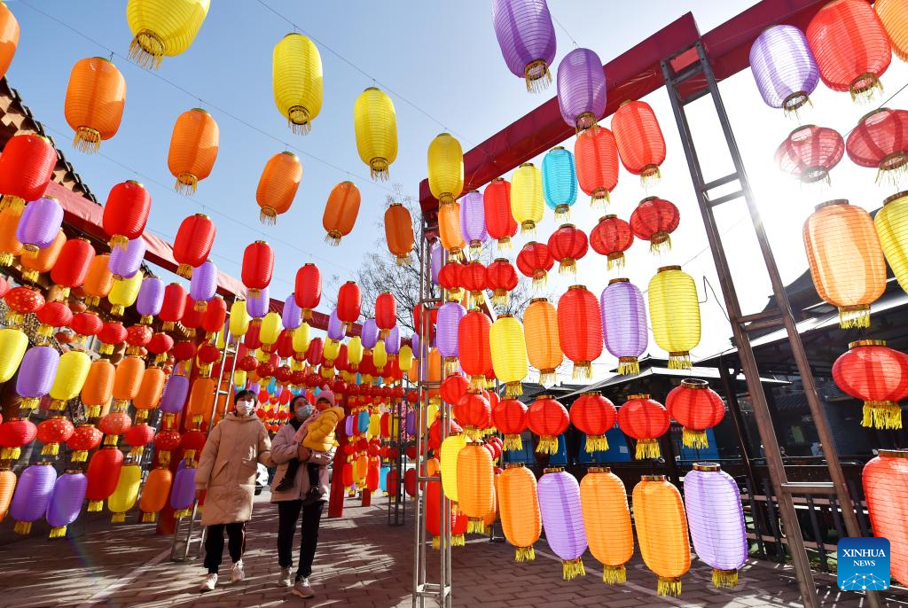 People enjoy lanterns in Zhengding County of Shijiazhuang, north China's Hebei Province, Jan. 18, 2023. This year's Spring Festival, or the Chinese New Year, falls on Jan. 22. (Photo by Zhang Xiaofeng/Xinhua)