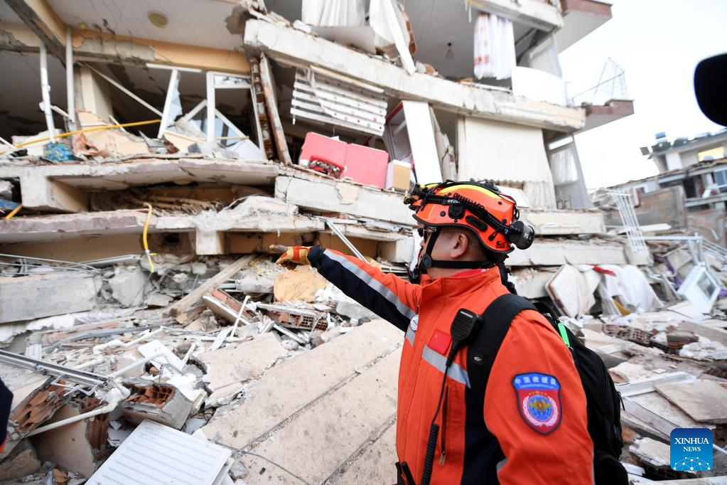 A member of the China Search and Rescue Team interacts with a rescue dog at a stadium in the southern province of Hatay, Trkiye, Feb. 8, 2023. (Xinhua/Shadati)