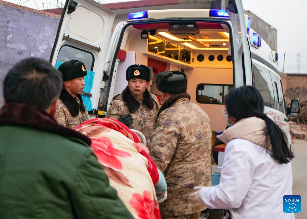 Soldiers transfer quake-affected mother and baby in Dahejia Township, Jishishan County, northwest China's Gansu Province, Dec. 19, 2023. The Chinese People's Liberation Army (PLA) and the People's Armed Police Force (PAPF) have deployed multiple rescue forces to quake-hit areas in response to a 6.2-magnitude earthquake that jolted northwest China's Gansu Province late Monday. (Photo by Xu Guo/Xinhua)