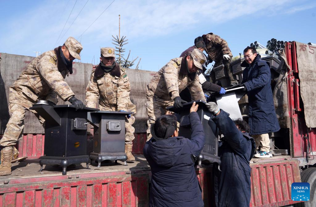 Soldiers unload stoves for quake-affected people in Shiyuan Township, Jishishan County, northwest China's Gansu Province, Dec. 21, 2023. The Chinese People's Liberation Army (PLA) and the People's Armed Police Force (PAPF) have deployed multiple rescue forces to quake-hit areas in response to a 6.2-magnitude earthquake that jolted northwest China's Gansu Province late Monday. (Xinhua/Zhang Yongjin)