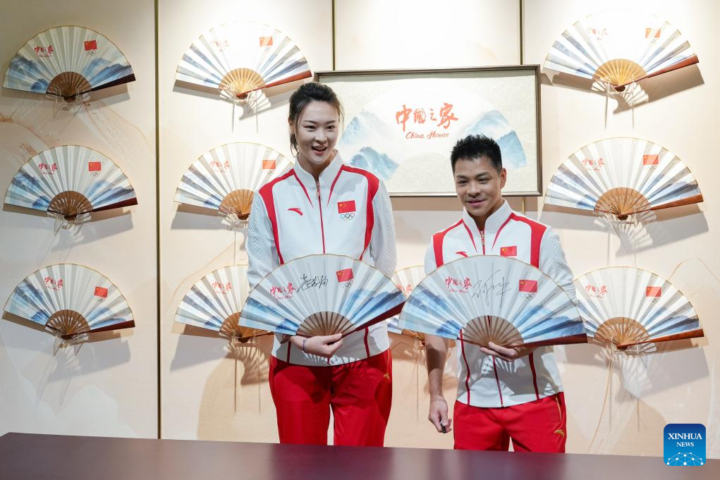 Hui Ruoqi (L), Olympic champion and former captain of the Chinese volleyball team, and He Chong, Olympic diving champion, pose for photos at the China House in Paris, France, on July 24, 2024. The China House for the Paris 2024 Olympic Games was inaugurated at the Hotel Salomon de Rothschild in Paris on Wednesday. (Xinhua/Ju Huanzong)