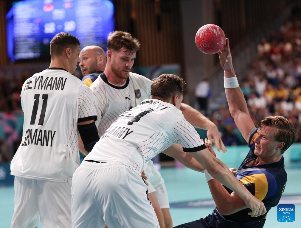 Jonathan Carlsbogaard (R) of Sweden competes during the handball Men's Preliminary Round Group A match between Germany and Sweden at Paris 2024 Olympic Games in Paris, France, July 27, 2024. (Xinhua/Li Jing)