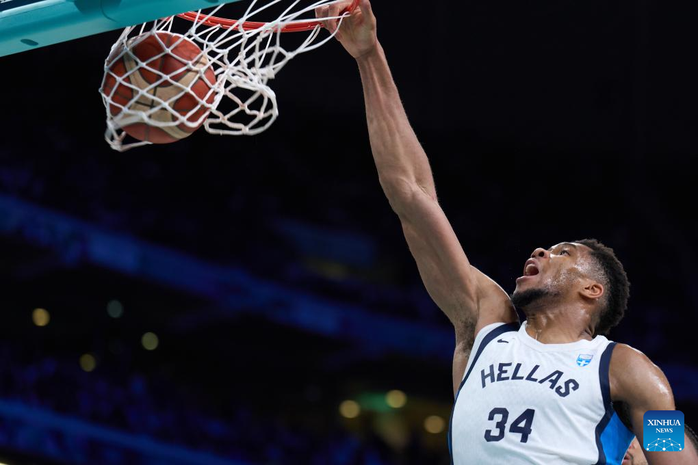Giannis Antetokounmpo of Greece dunks during the men's basketball group A match against Canada at the Paris 2024 Olympic Games in Pierre Mauroy Stadium at Lille, France, on July 27, 2024. (Xinhua/Meng Dingbo)