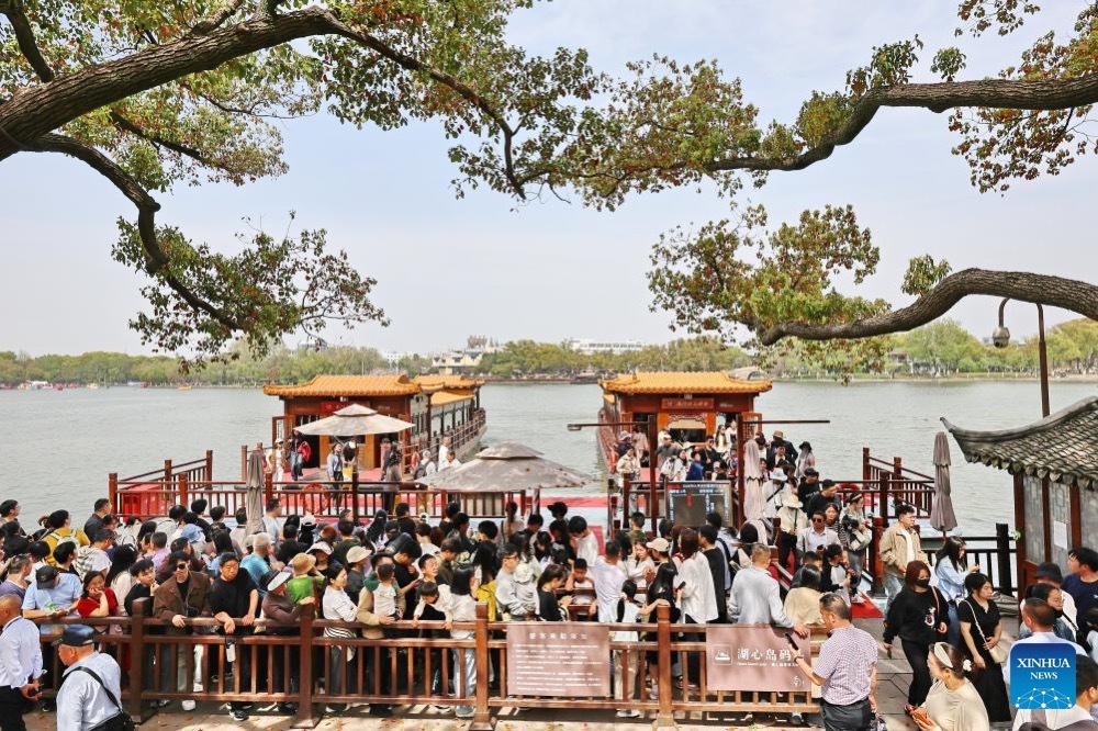 Tourists take boat rides at Nanhu Scenic Area during the Qingming Festival holiday in Jiaxing City, east China's Zhejiang Province, April 5, 2026. (Xinhua)