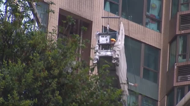 HK rainstorm alert traps six workers on suspended platforms at residential tower