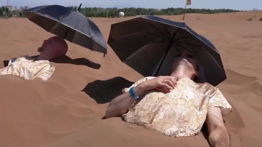 Watch This | Foreign journalists experience sand therapy in Xinjiang, China