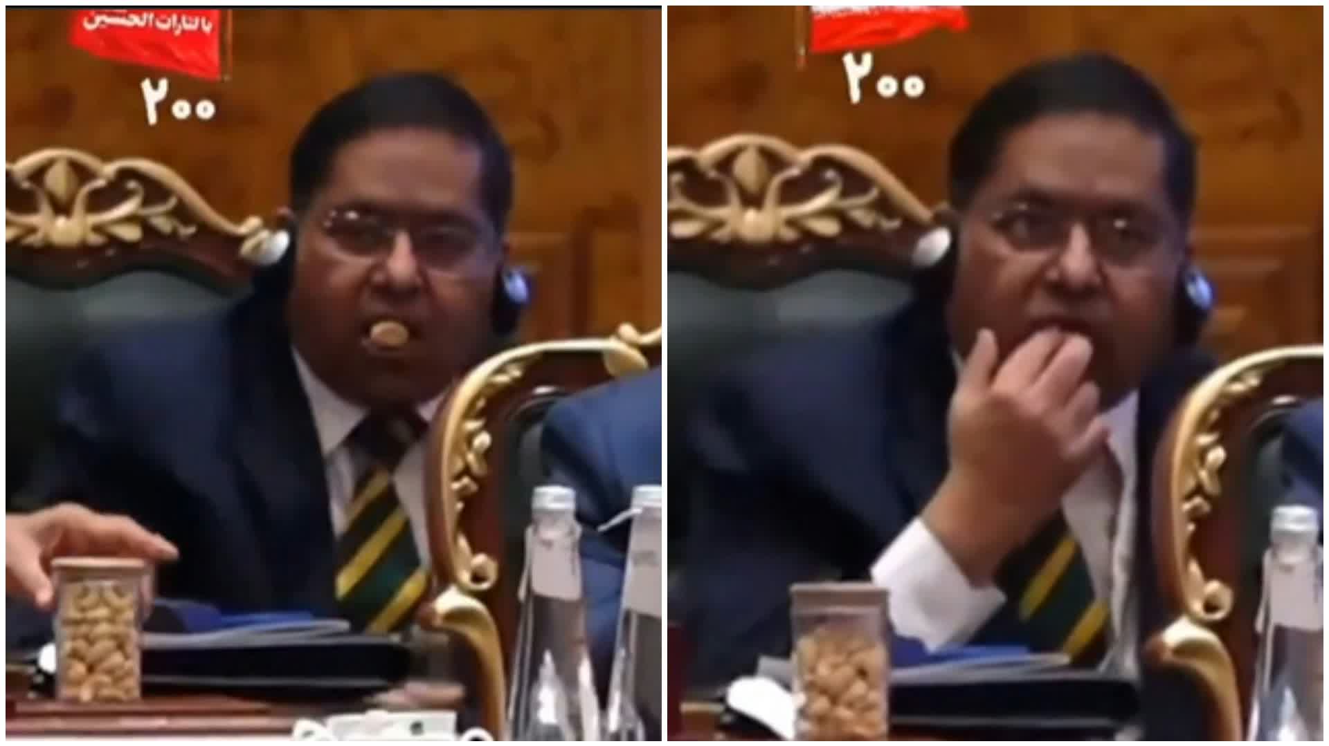 Iranian President speaks at BRICS Summit as Indian official behind him snacks on nuts and licks fingers, sparking debate