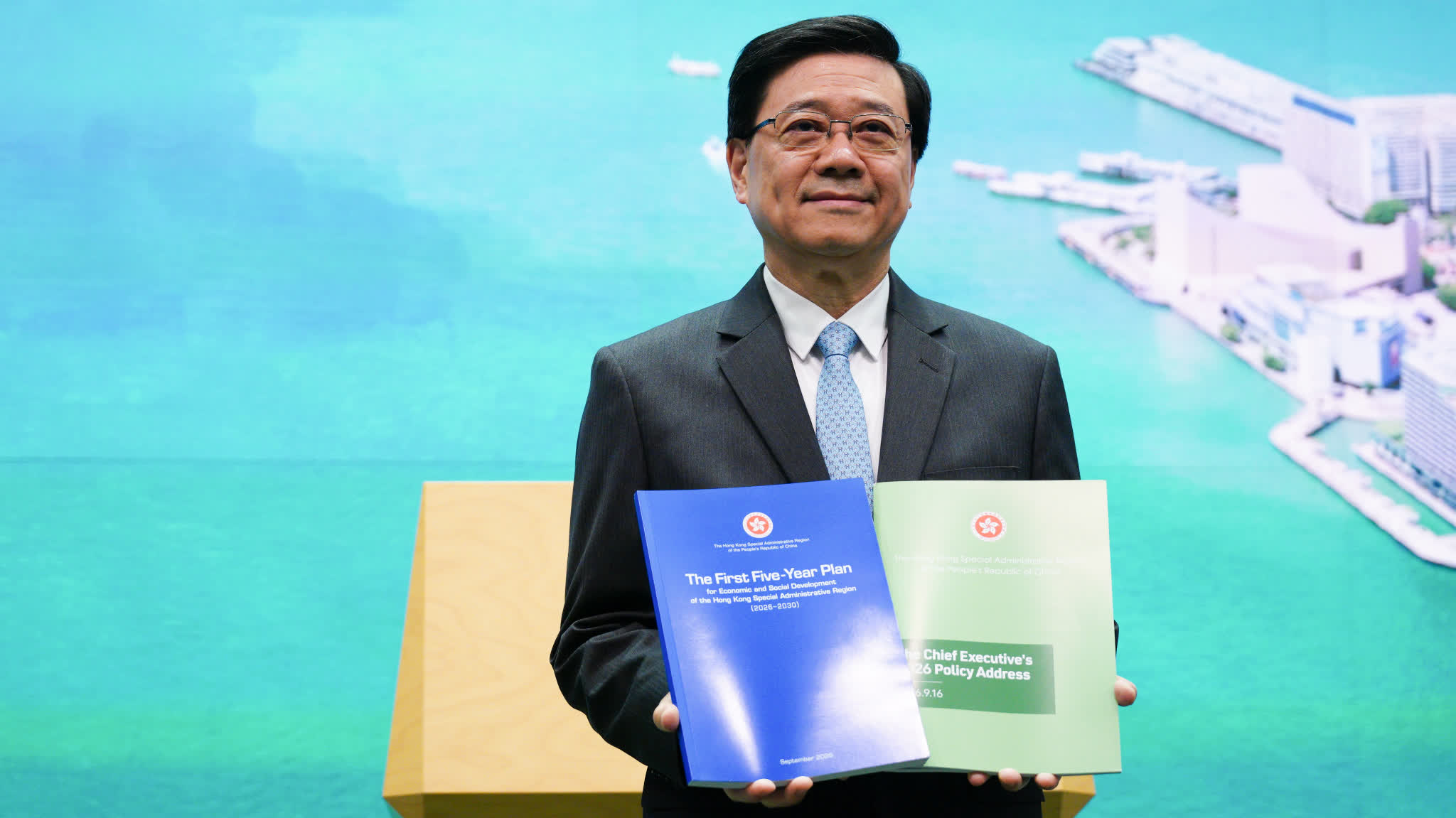 John Lee: Blue cover of first Five-Year Plan symbolises openness and stability, two-volume summary to highlight key points