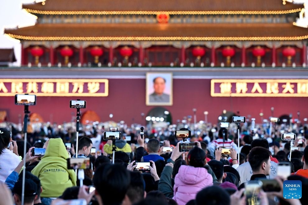 People attend a flag-raising ceremony marking the 77th anniversary of the founding of the People's Republic of China at Tian'anmen Square in Beijing, capital of China, Oct. 1, 2026. (Xinhua)