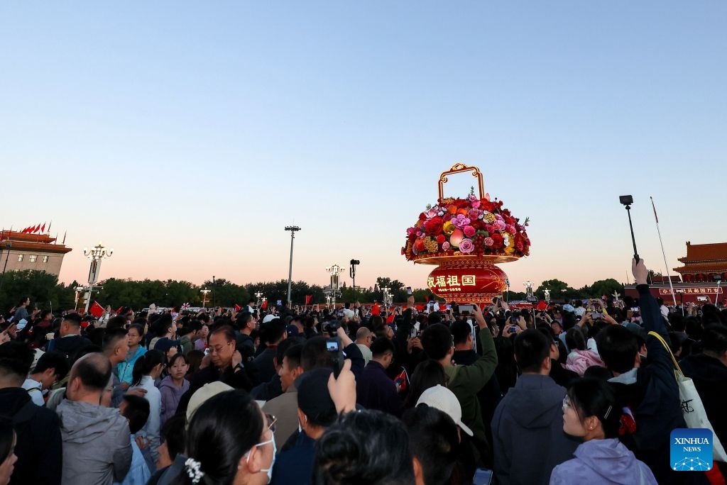People attend a flag-raising ceremony marking the 77th anniversary of the founding of the People's Republic of China at Tian'anmen Square in Beijing, capital of China, Oct. 1, 2026. (Xinhua)