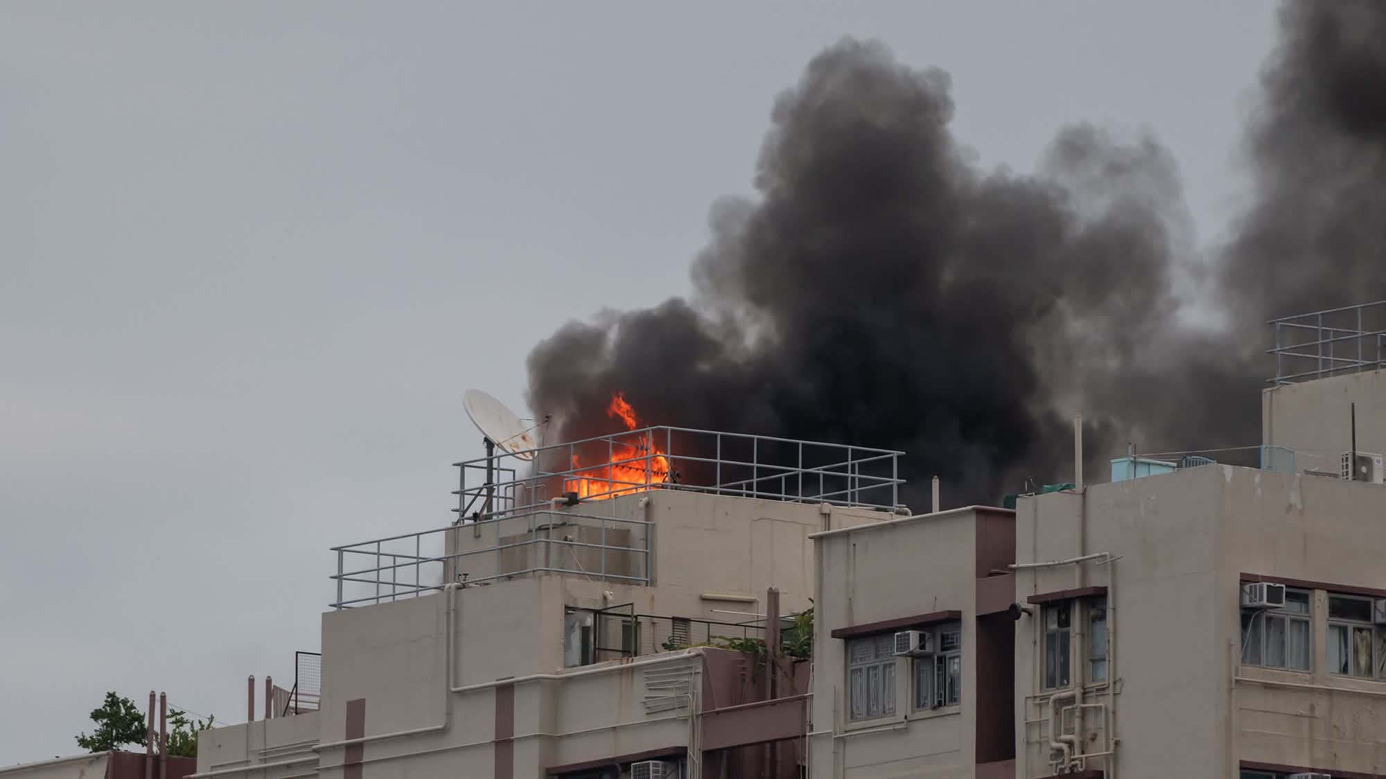 Fire breaks out on rooftop of Mong Kok residential building, sending thick smoke into sky