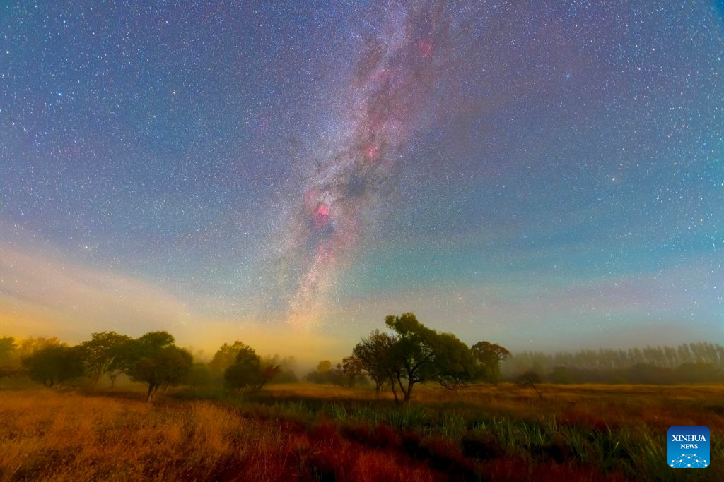 This stacked composite photo taken on Oct. 7, 2026 shows the autumn scenery under the Milky Way at the Jingpohu Global Geopark in Mudanjiang City, northeast China's Heilongjiang Province. (Wang Baoxun/Xinhua)
