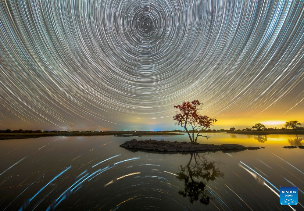 This stacked composite photo taken on Oct. 12, 2026 shows the scenery under starry sky at the Jingpohu Global Geopark in Mudanjiang City, northeast China's Heilongjiang Province. (Wang Baoxun/Xinhua)